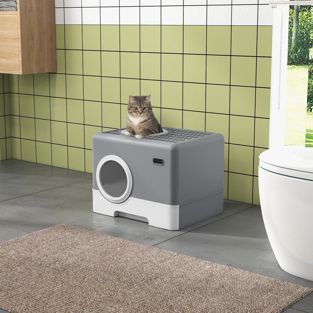 En rymlig och diskret grå kattlåda placerad i ett badrum, med en katt som vilar på det gallerförsedda taket.