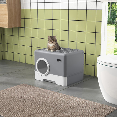 En rymlig och diskret grå kattlåda placerad i ett badrum, med en katt som vilar på det gallerförsedda taket.